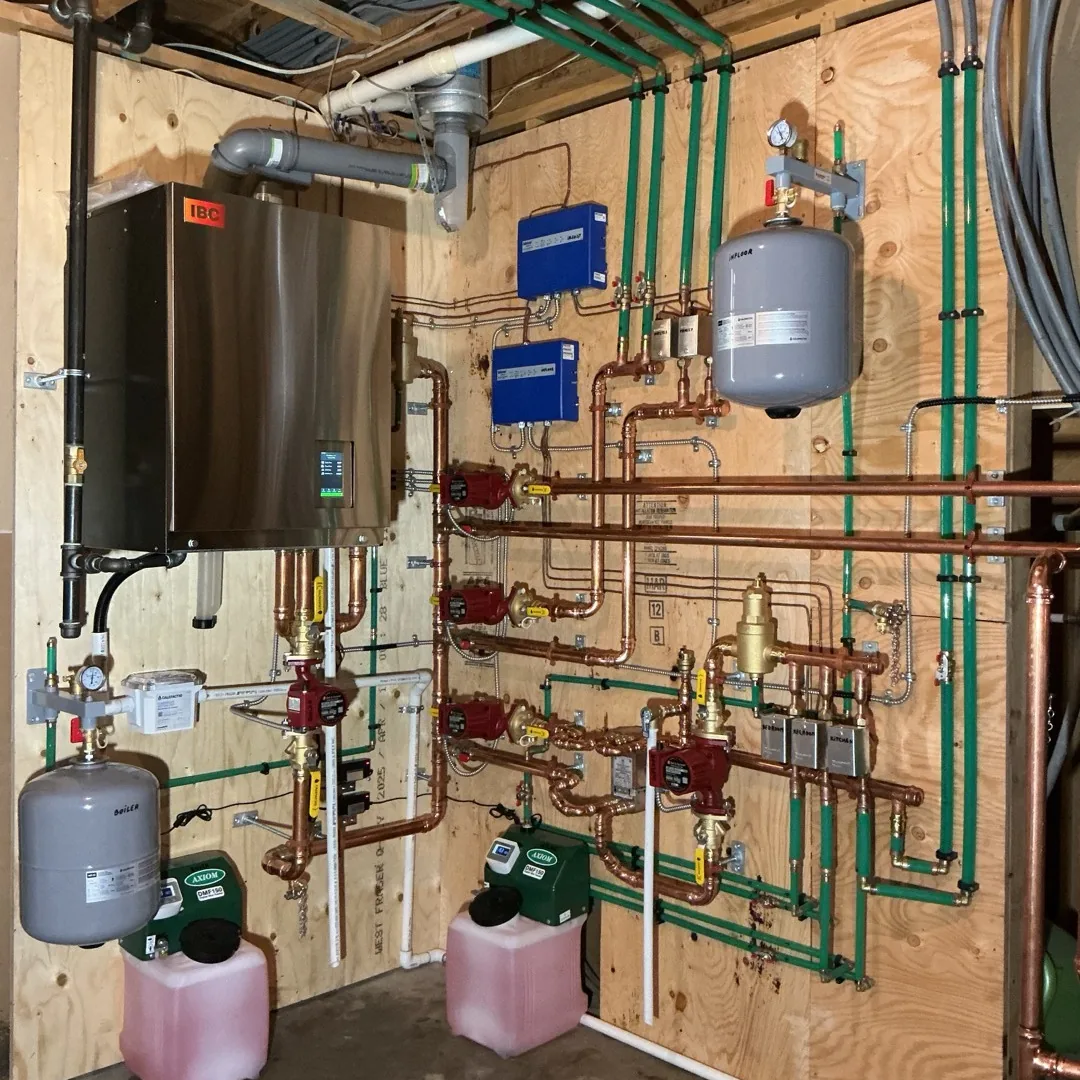 High-efficiency IBC wall-mounted boiler and rebuilt copper distribution manifold installed by Arpi's in a Calgary home