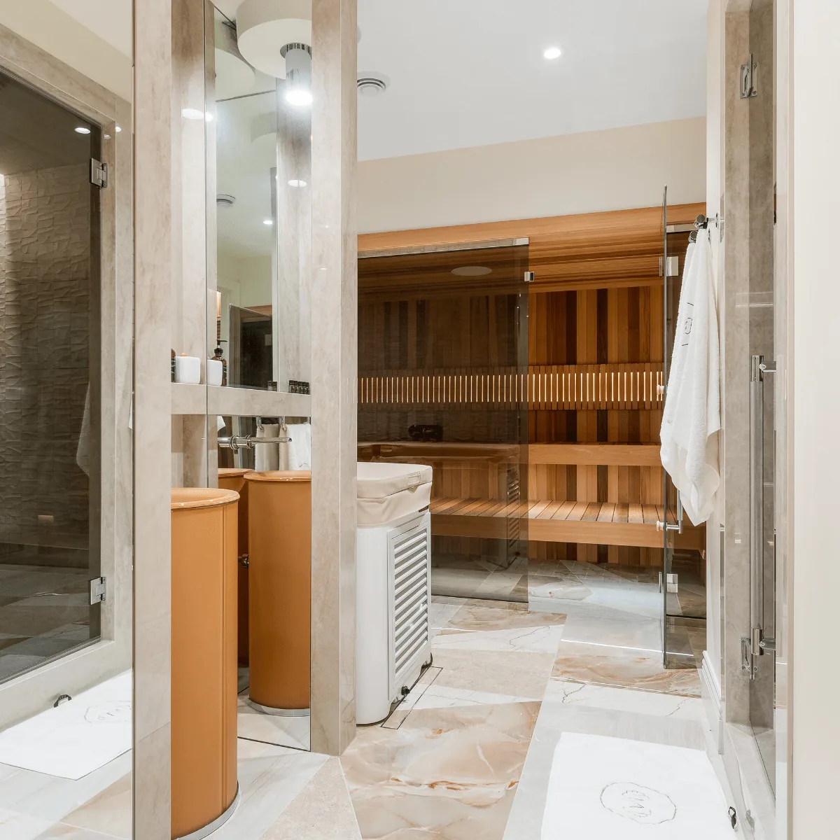 Luxury home spa bathroom with a cedar sauna and glass-enclosed steam shower, plumbing by Arpi's in Calgary