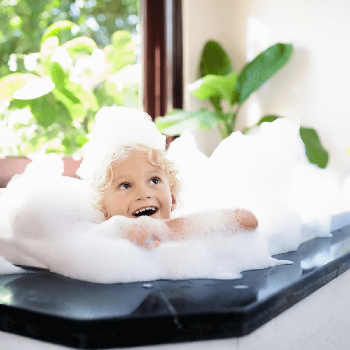 Child enjoying a warm bubble bath powered by a combination boiler water heater installed by Arpi's in Calgary