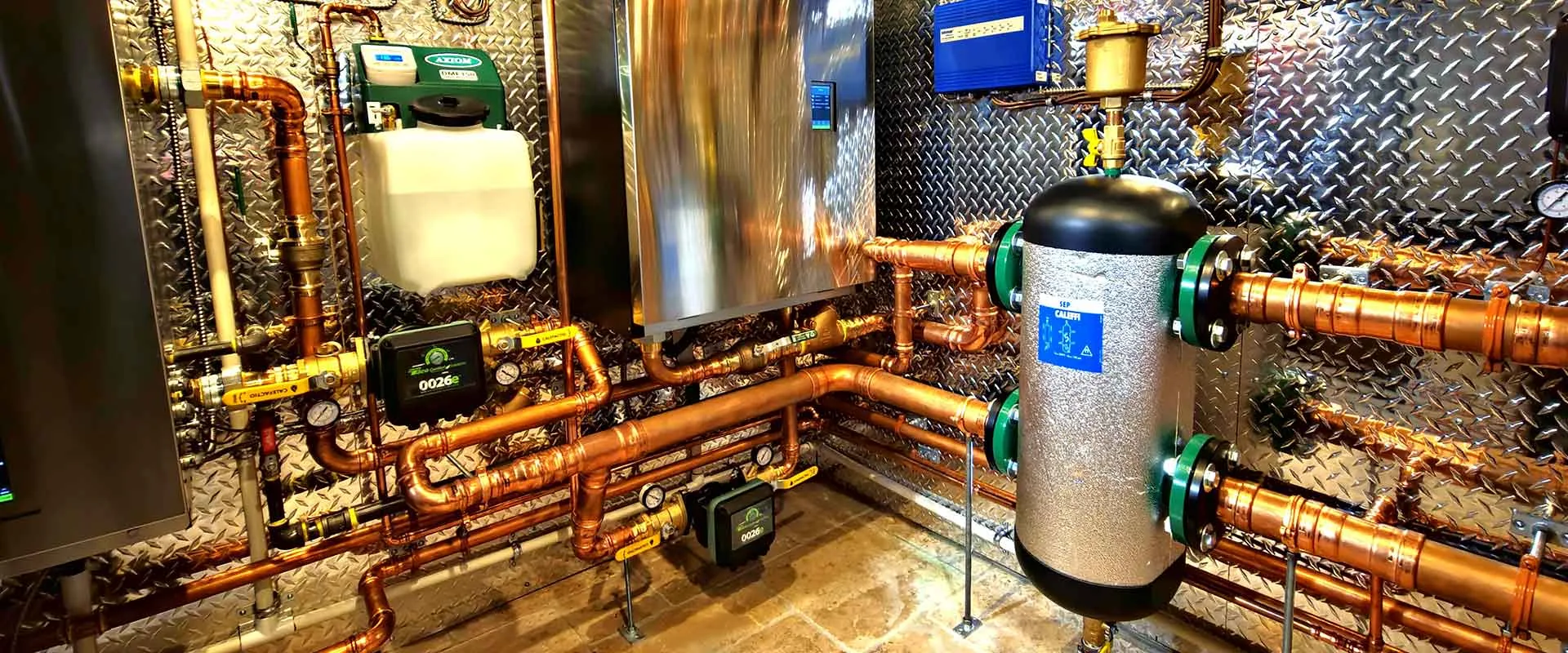 High-efficiency IBC boiler installation with copper piping and Caleffi hydronic separator in a Calgary mechanical room by Arpi's heating and plumbing