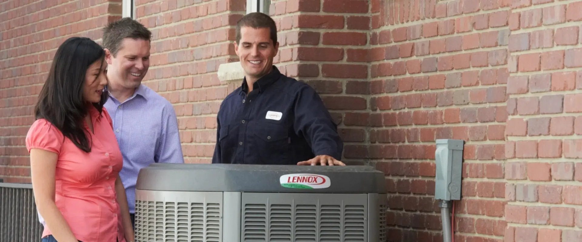 Arpi's Calgary tech explaining Lennox air conditioner operation to homeowners