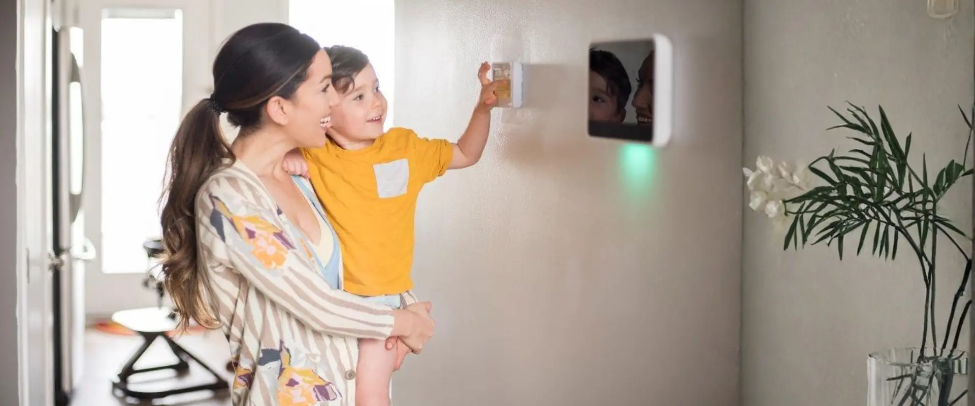 Calgary mom and son adjusting the thermostat for summer