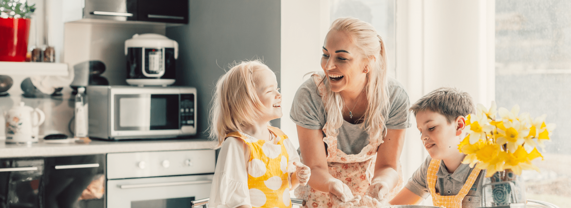 Mom laughing with her kids in the kitchen