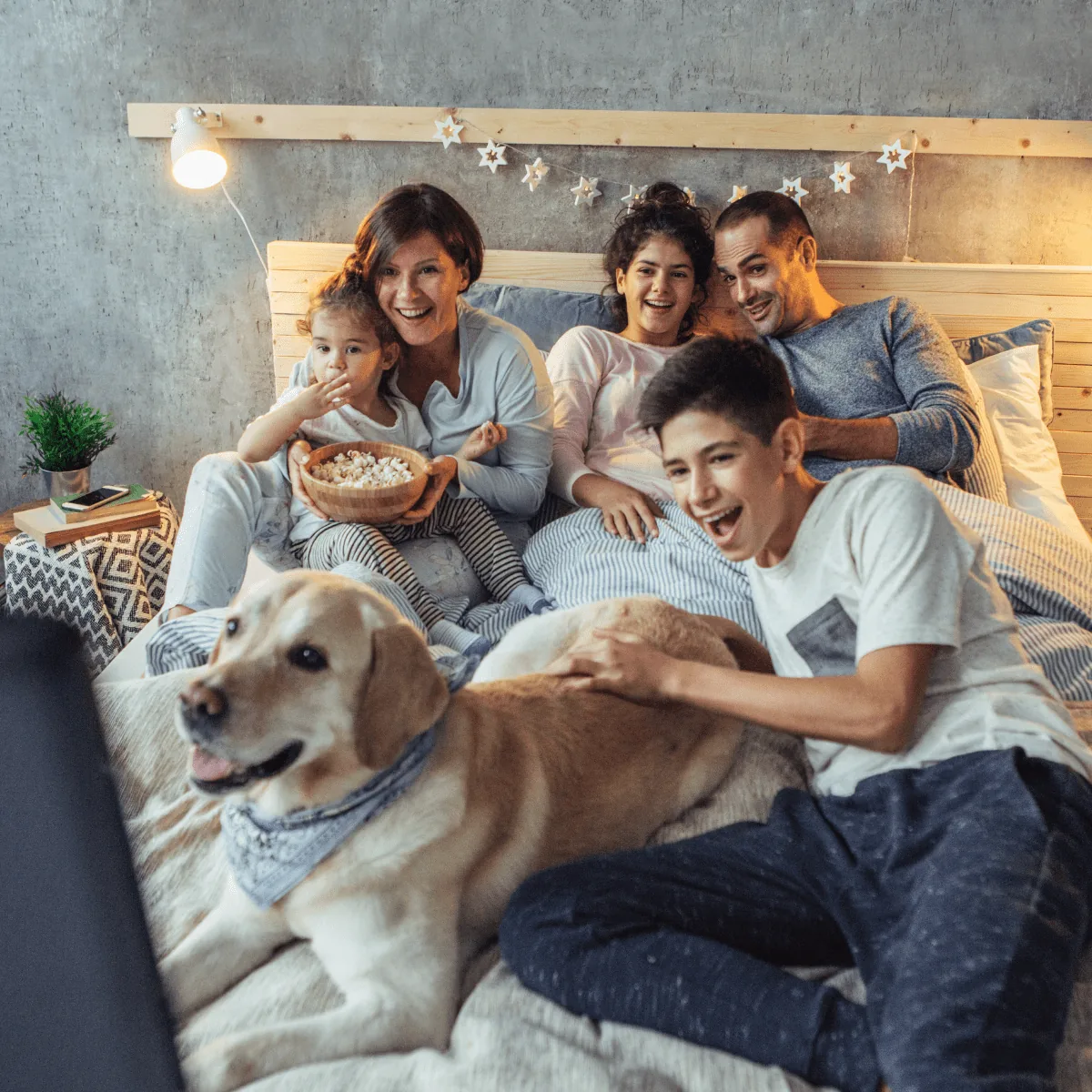 Comfortable family relaxing at home with reliable hot water from a water heater chosen with help from Arpi's in Calgary